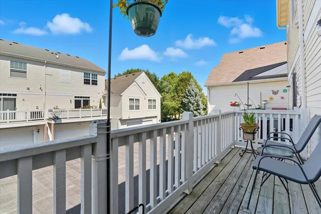 a view of balcony with wooden floor and seating space