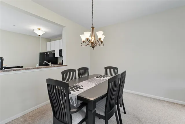 a dining room with furniture and chandelier