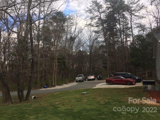 1825 Emanuel Church Road Rockwell, NC 28138 - Photo 15 of 21 a view of a yard with a car parked in it