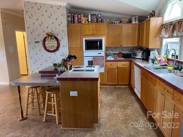 1825 Emanuel Church Road Rockwell, NC 28138 - Photo 17 of 21 a kitchen with stainless steel appliances a stove a sink and a refrigerator
