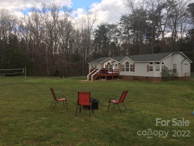 1825 Emanuel Church Road Rockwell, NC 28138 - Photo 2 of 21 a wooden bench sitting in a grassy field