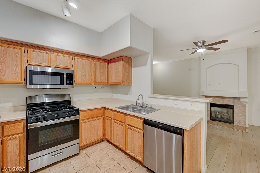 9050 West Warm Springs Road, Unit 1147 Las Vegas, NV 89148 - Photo 15 of 36 A well-appointed kitchen features ample cabinetry, a full suite of stainless steel appliances, and a convenient pass-through to the adjacent living area.