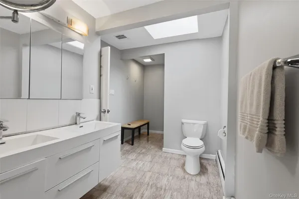 a white toilet sitting next to a shower