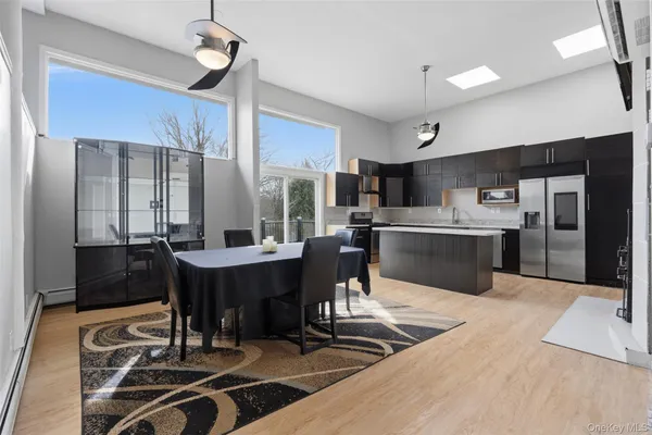 a large kitchen with a table and chairs