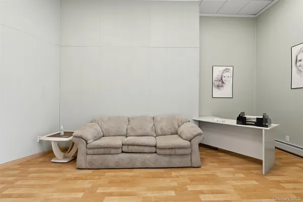 a bedroom with a bed couch and a window