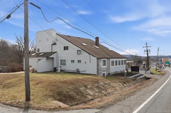 a view of a house with a yard and garage