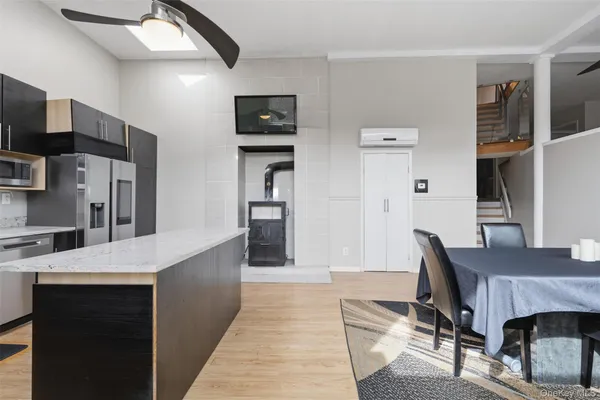 a open kitchen with stainless steel appliances kitchen island a refrigerator sink and cabinets