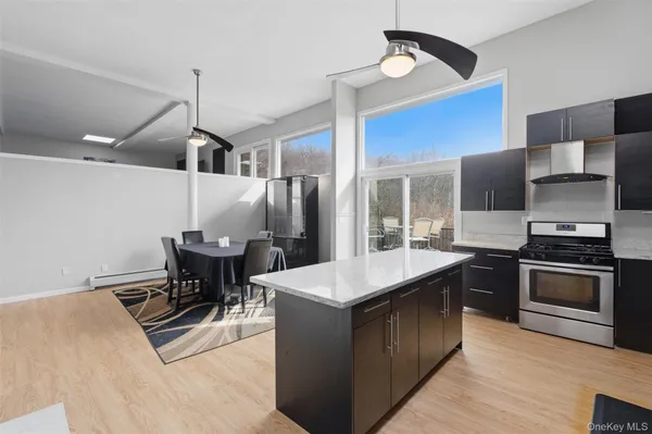 a kitchen with kitchen island granite countertop a stove a sink and a refrigerator