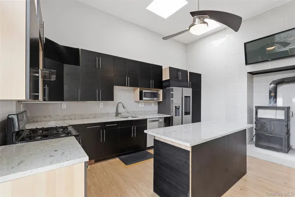 a kitchen with a sink a stove and refrigerator