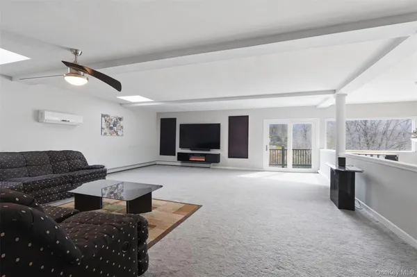 a living room with furniture window and a flat screen tv