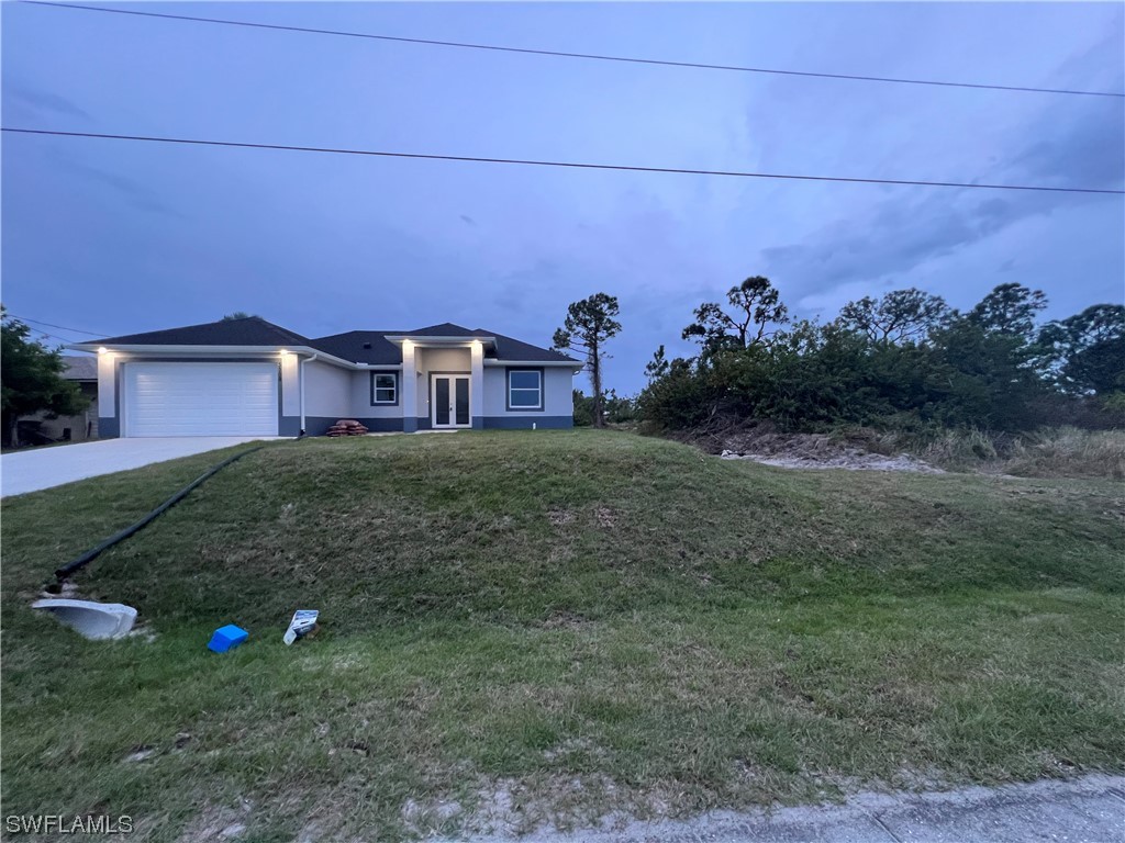 2612 16th Street West Lehigh Acres, FL 33971 - Photo 1 of 25 a front view of a house with a yard