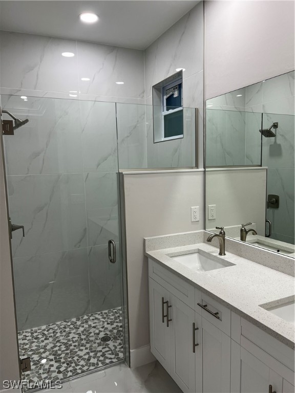 2612 16th Street West Lehigh Acres, FL 33971 - Photo 17 of 25 a bathroom with a sink a shower and a mirror