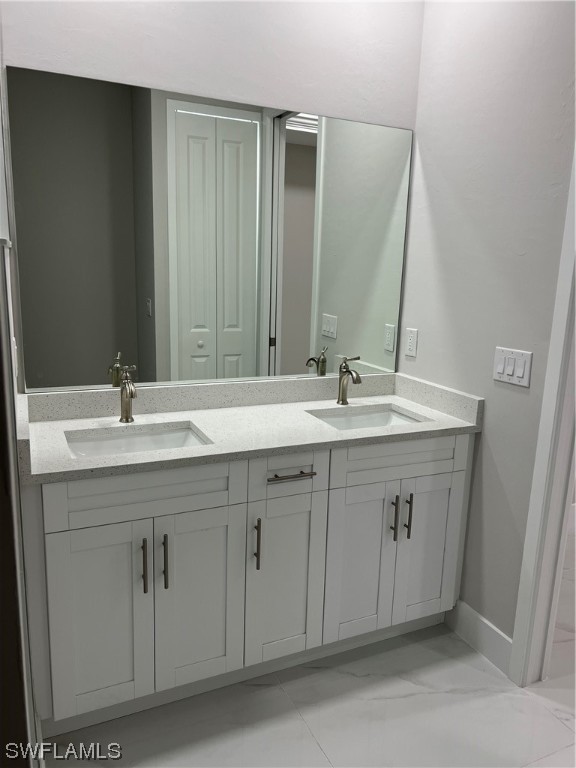 2612 16th Street West Lehigh Acres, FL 33971 - Photo 18 of 25 a bathroom with a double vanity sink and a mirror