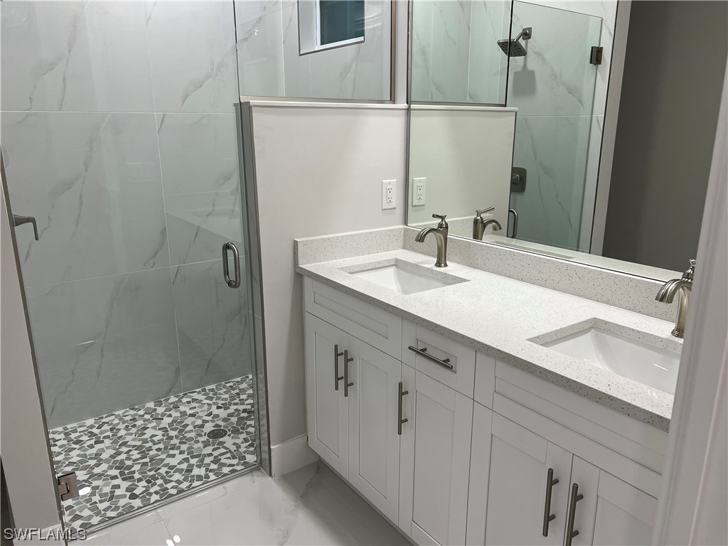 2612 16th Street West Lehigh Acres, FL 33971 - Photo 19 of 25 a bathroom with a sink and a mirror