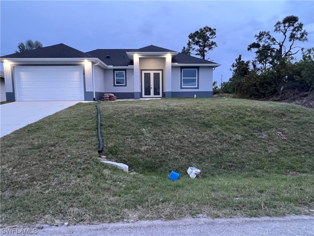 2612 16th Street West Lehigh Acres, FL 33971 - Photo 2 of 25 a front view of a house with a yard