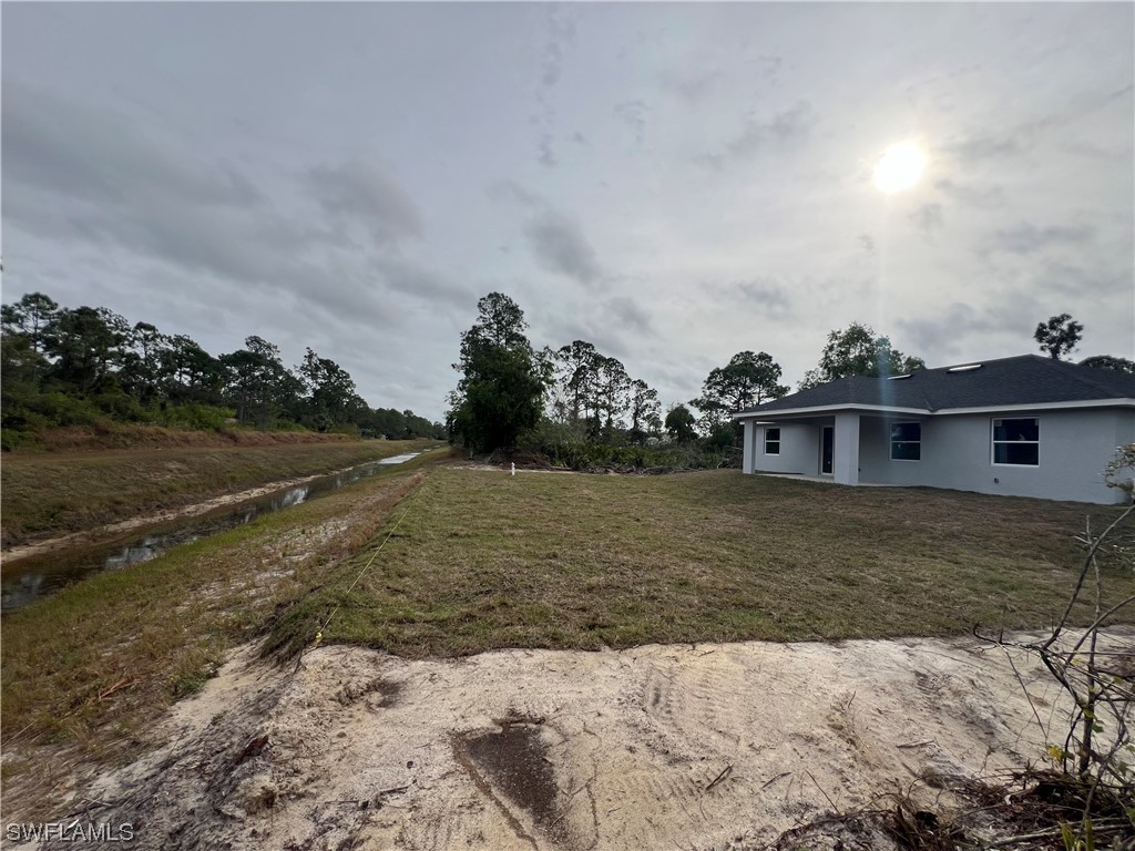 2612 16th Street West Lehigh Acres, FL 33971 - Photo 22 of 25 a view of a house with a yard