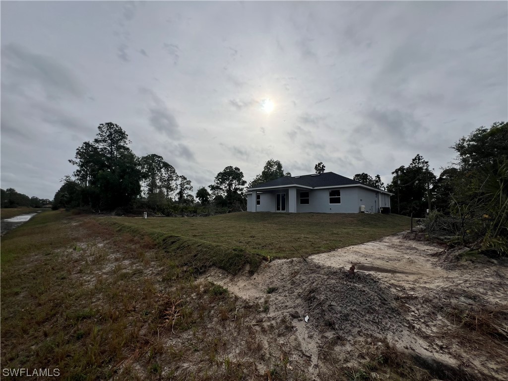2612 16th Street West Lehigh Acres, FL 33971 - Photo 23 of 25 a view of a green field with lots of trees in the background