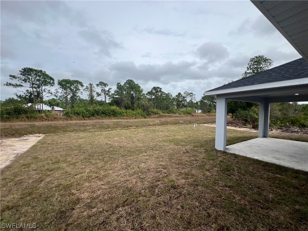 2612 16th Street West Lehigh Acres, FL 33971 - Photo 25 of 25 a backyard of a house with lots of green space