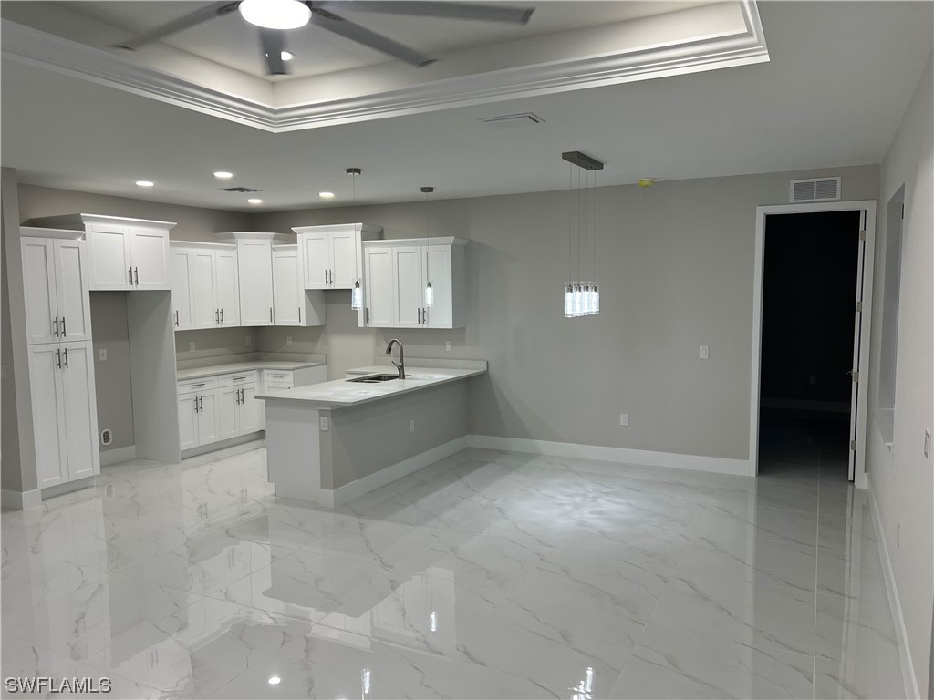2612 16th Street West Lehigh Acres, FL 33971 - Photo 5 of 25 a large kitchen with kitchen island a sink stainless steel appliances and cabinets