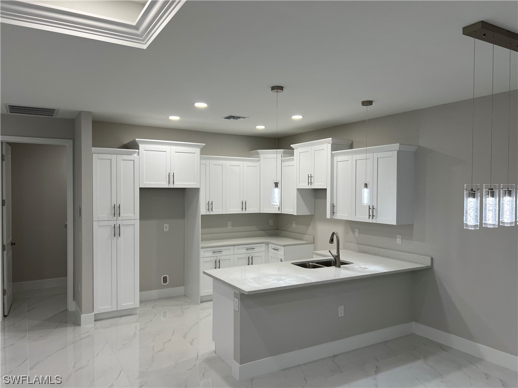 2612 16th Street West Lehigh Acres, FL 33971 - Photo 6 of 25 a view of kitchen island a sink stainless steel appliances and cabinets