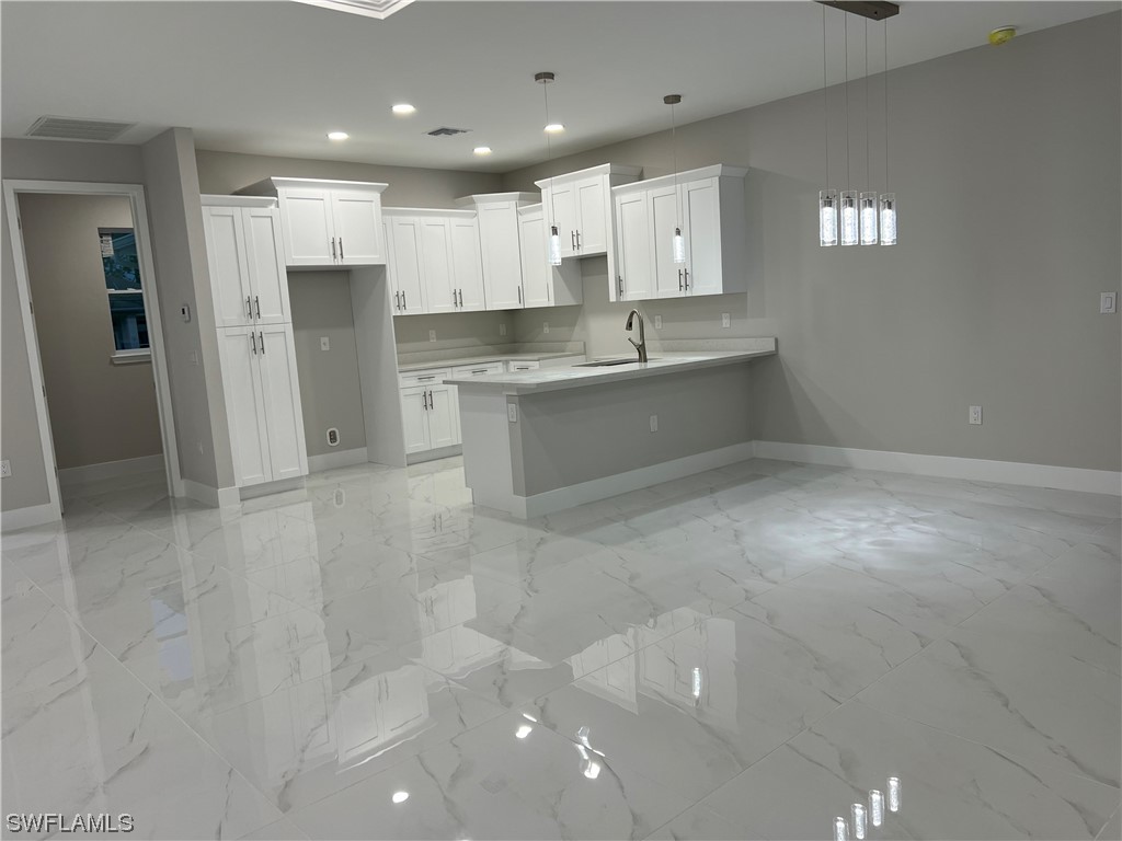 2612 16th Street West Lehigh Acres, FL 33971 - Photo 7 of 25 a large kitchen with stainless steel appliances lots of counter top space