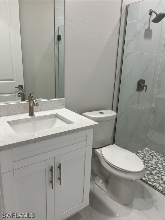 2612 16th Street West Lehigh Acres, FL 33971 - Photo 10 of 25 a bathroom with a sink a toilet and a mirror