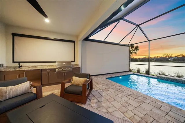 a bedroom with a bed chandelier and a window