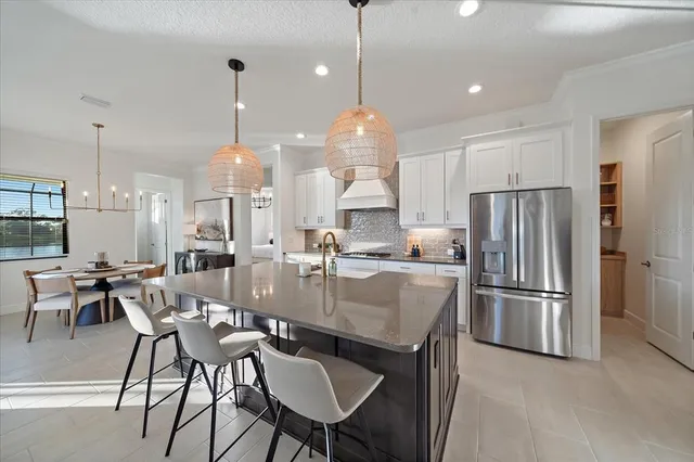 a kitchen with stainless steel appliances granite countertop a sink a stove and a refrigerator