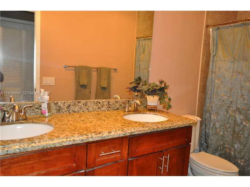 3985 Southwest 152nd Avenue Miramar, FL 33027 - Photo 15 of 26 a bathroom with a granite countertop sink and a mirror