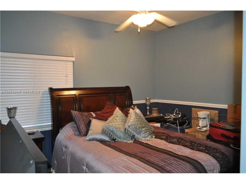 3985 Southwest 152nd Avenue Miramar, FL 33027 - Photo 19 of 26 a bed sitting in a bedroom next to a window