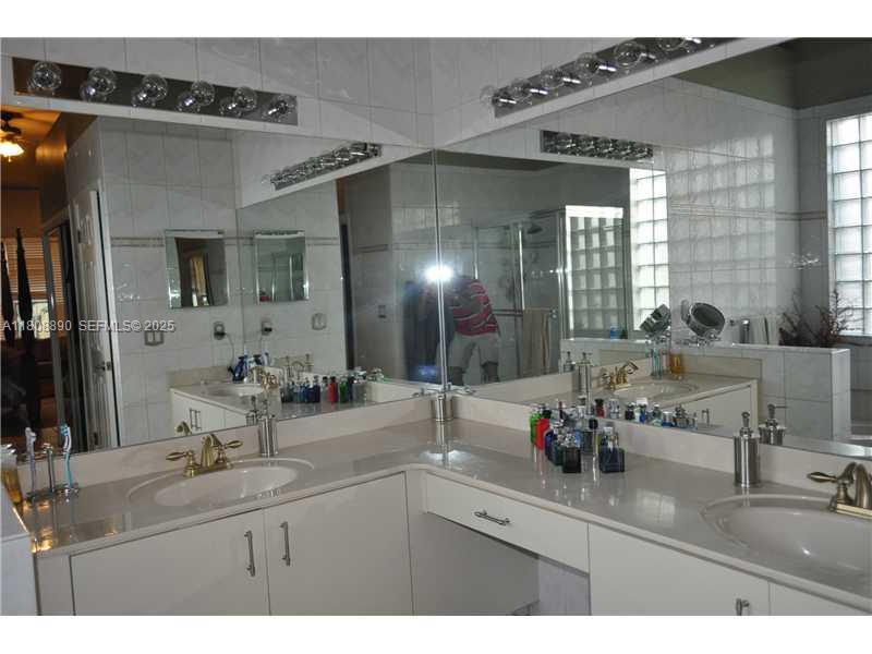 3985 Southwest 152nd Avenue Miramar, FL 33027 - Photo 23 of 26 a bathroom with a sink and a mirror