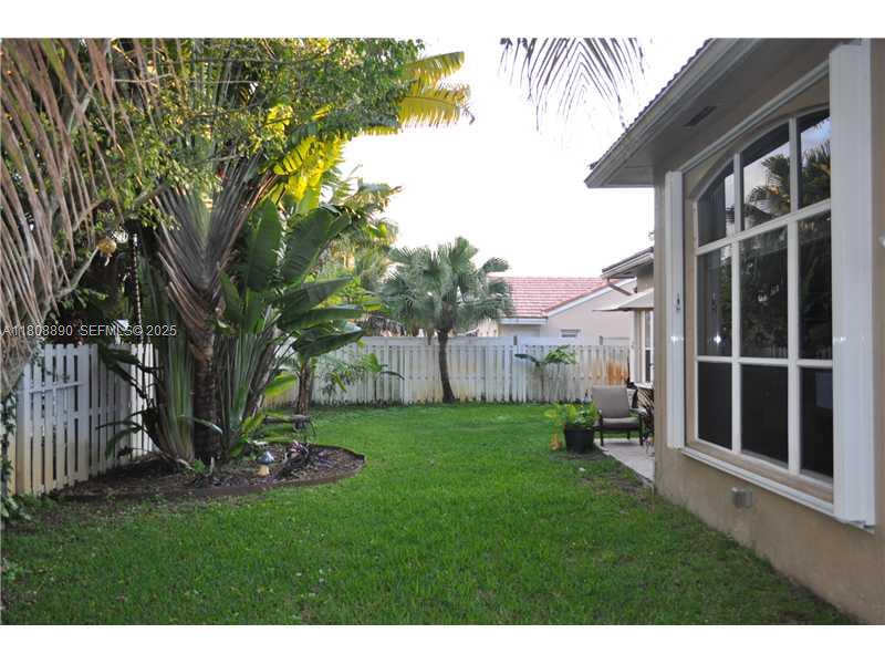 3985 Southwest 152nd Avenue Miramar, FL 33027 - Photo 26 of 26 a view of a backyard with plants and a large tree