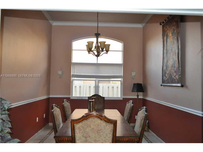 3985 Southwest 152nd Avenue Miramar, FL 33027 - Photo 7 of 26 a view of a dining room with furniture and a chandelier