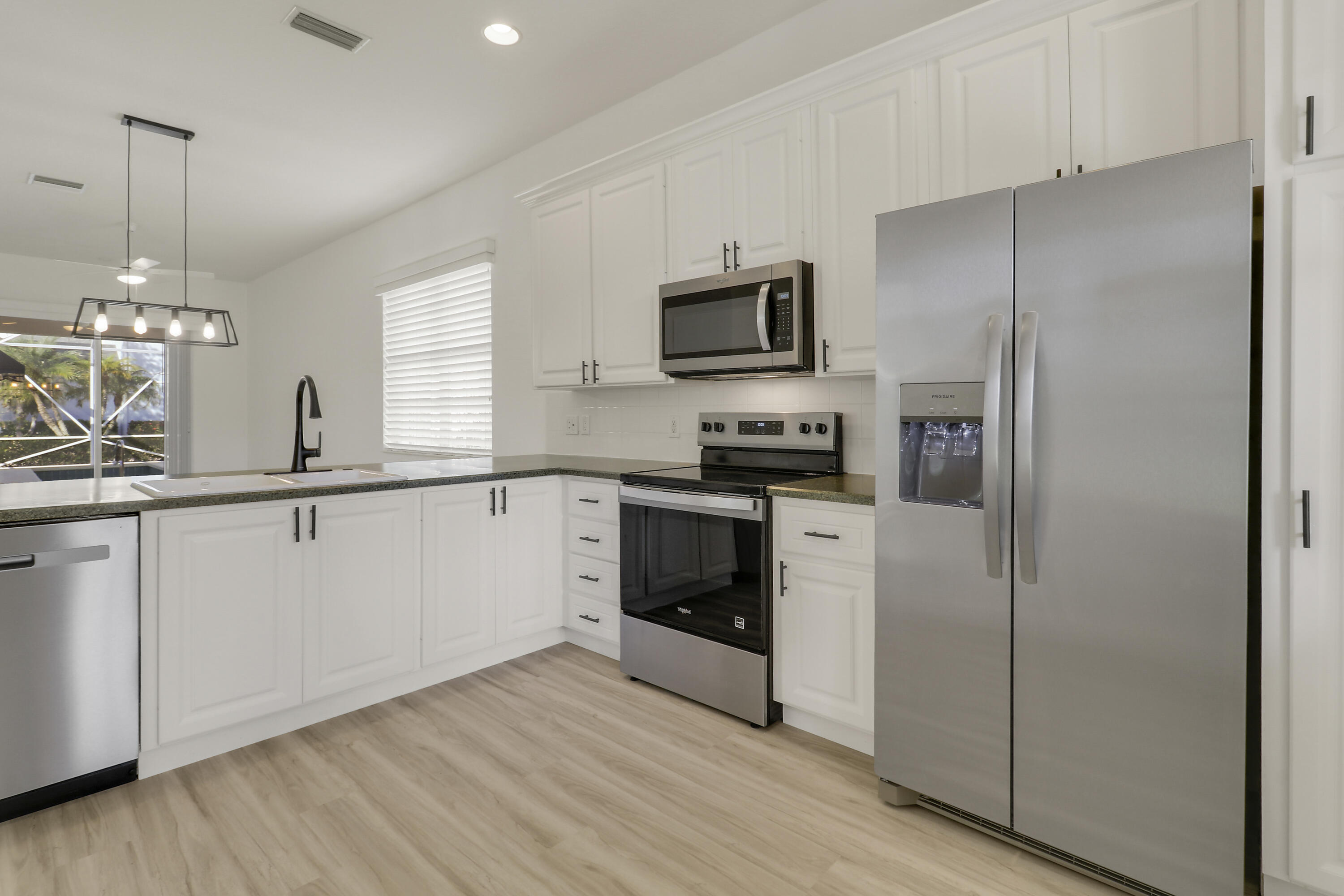 229 Sugar Apple Way Jupiter, FL 33458 - Photo 12 of 46 Kitchen Open to Living & Dining Room