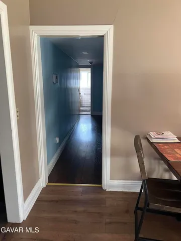 a view of a hallway and wooden floor