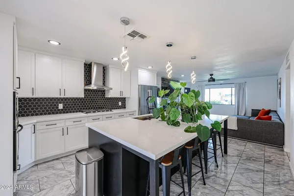 a kitchen with a table chairs sink and cabinets