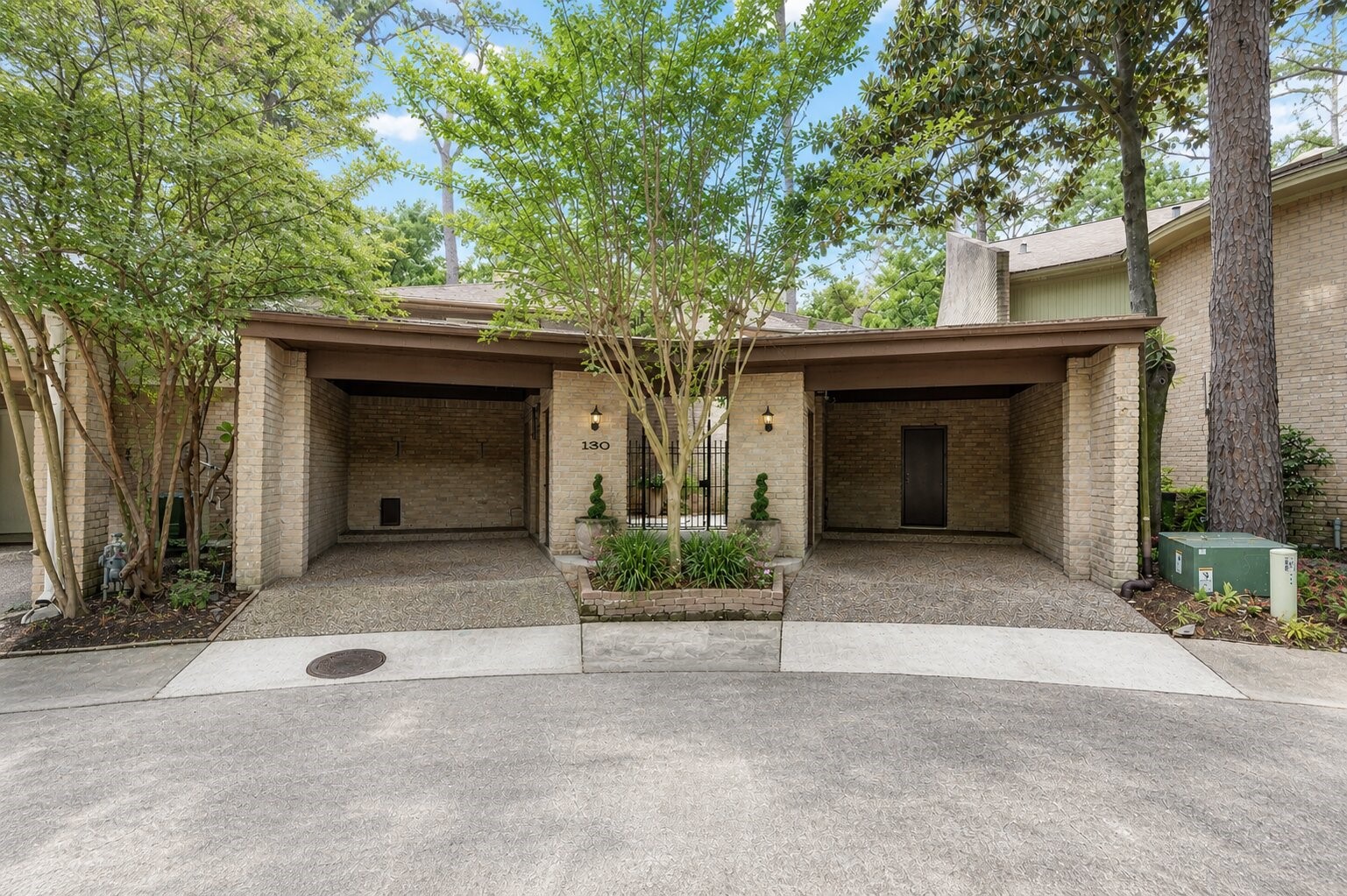 201 Vanderpool Lane, Unit 130 Houston, TX 77024 - Photo 31 of 41 This Mid-Century Modern-inspired townhome features dual carports (large enough to accommodate SUVs) that flank the gated central covered entrance to the property.