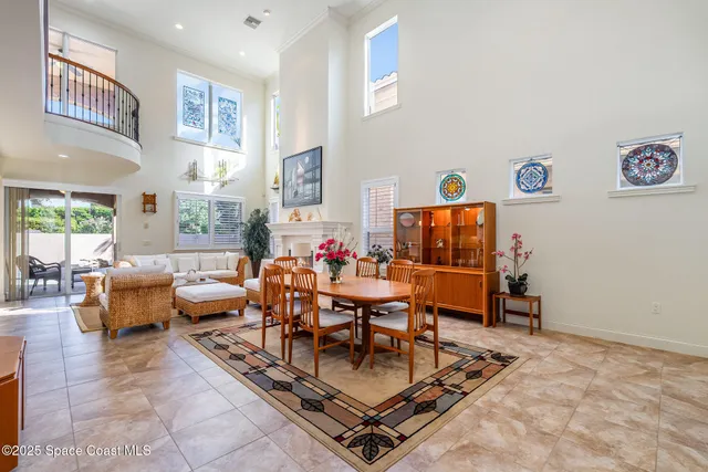 a kitchen with stainless steel appliances kitchen island granite countertop a table chairs sink and cabinets