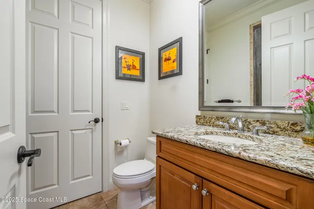 a spacious bedroom with a bed and wooden floor