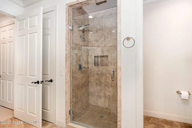 a en suite bathroom with a granite countertop sink and a mirror