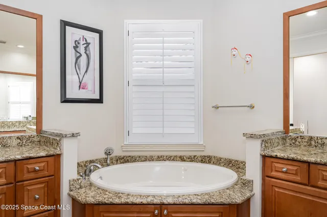 a spacious bathroom with a sink and a mirror
