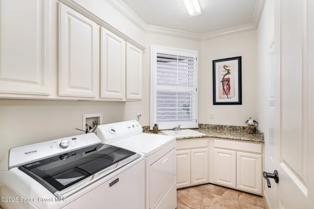 an aerial view of a house with a yard and potted plants