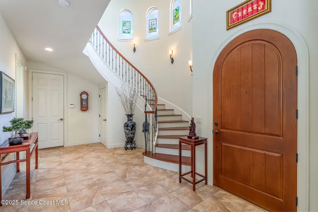 a living room with furniture a fireplace and a large window