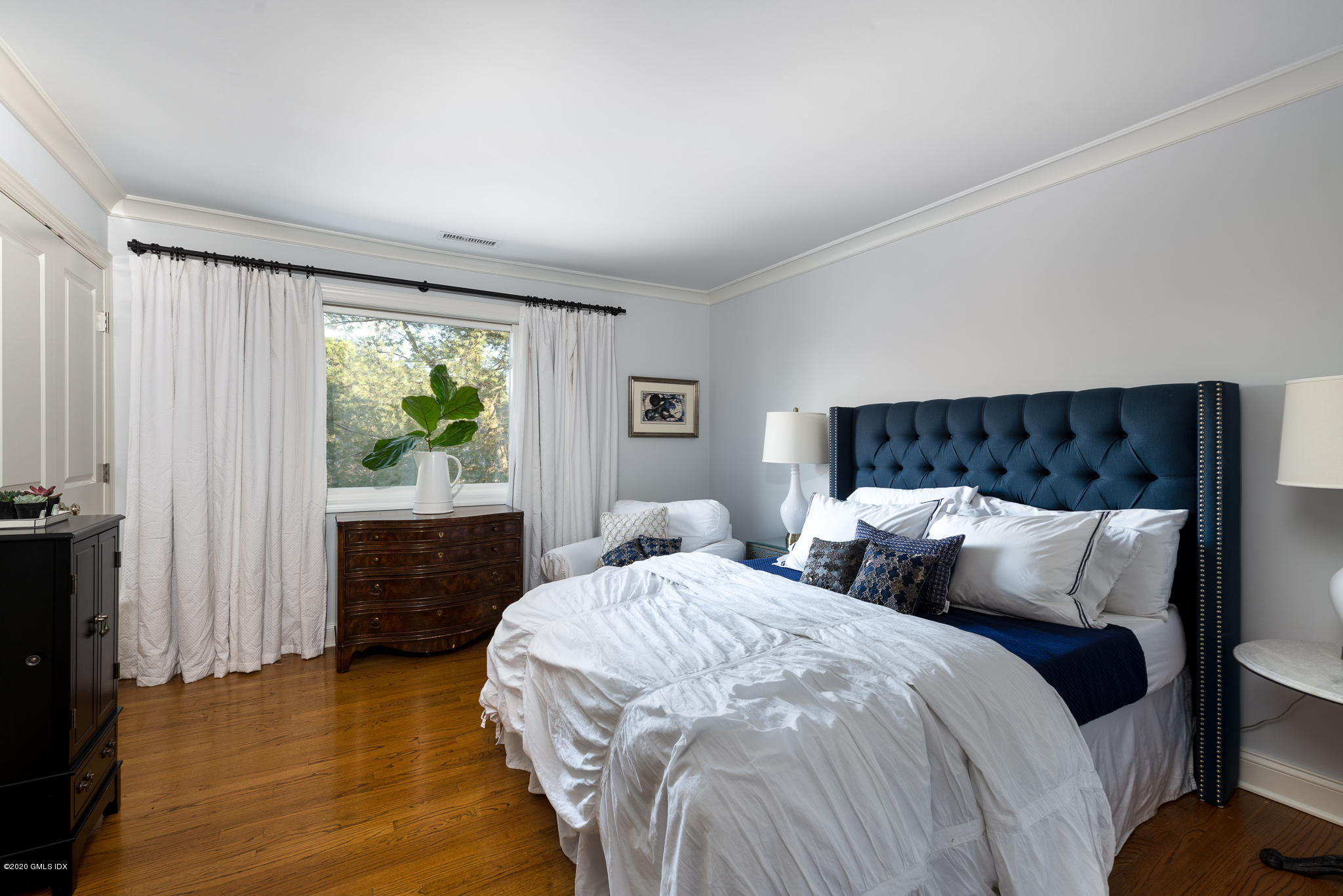 8 Whiffletree Way, Unit 8 Riverside, CT 06878 - Photo 5 of 8 a bedroom with a bed and a window