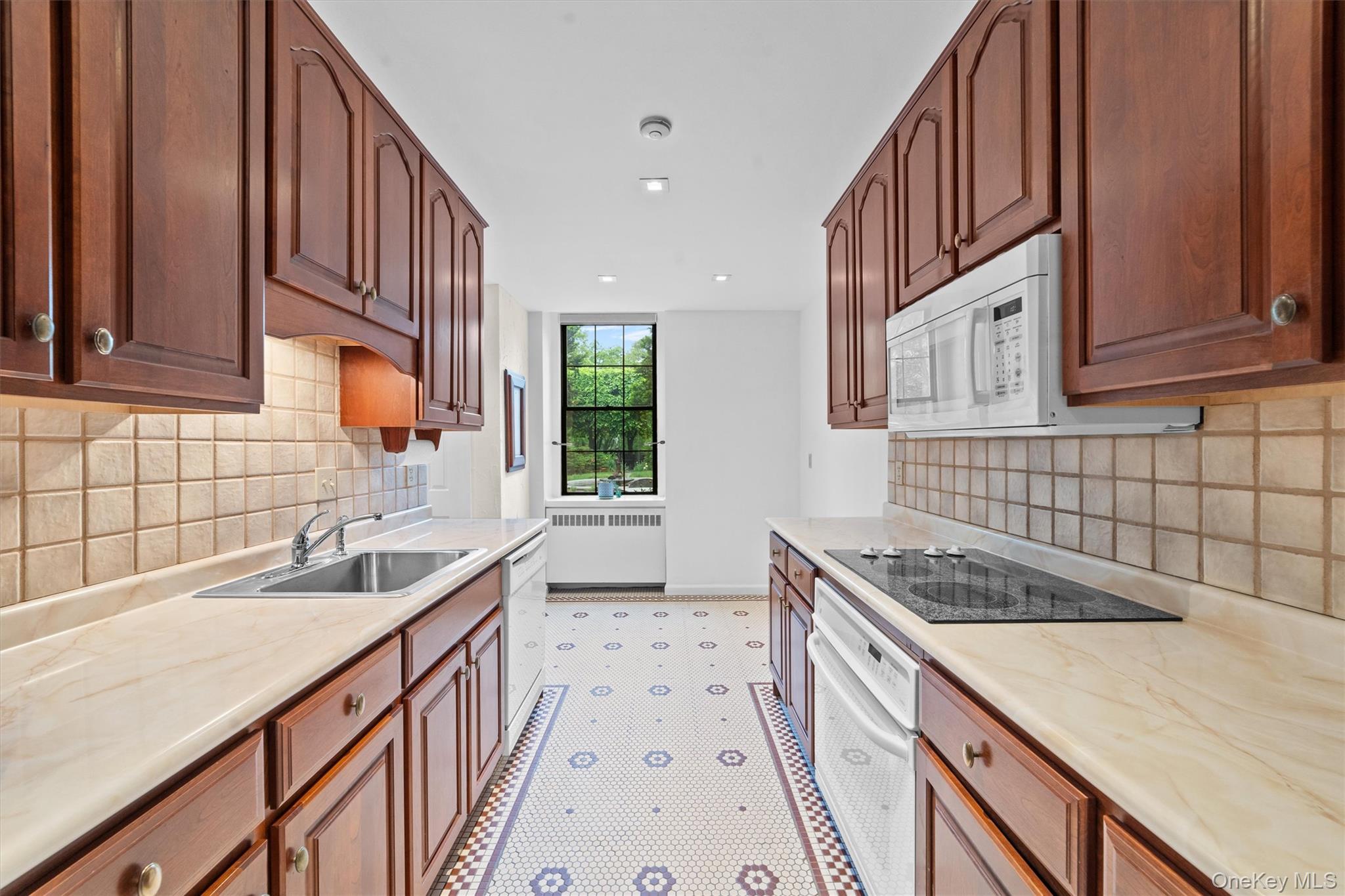 341 Furnace Dock Road, Unit 5 Cortlandt Manor, NY 10567 - Photo 11 of 41 a kitchen with granite countertop a sink stove and cabinets