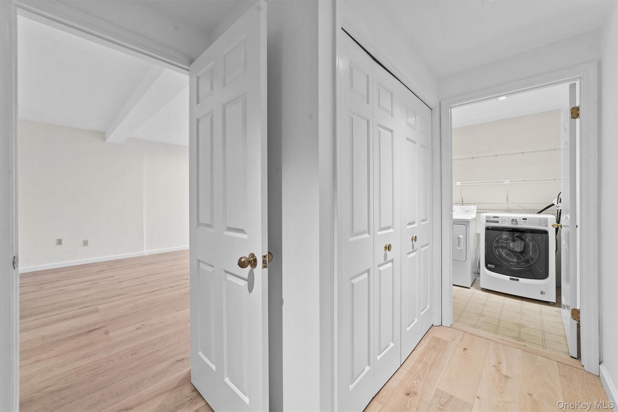 341 Furnace Dock Road, Unit 5 Cortlandt Manor, NY 10567 - Photo 16 of 41 a view of a hallway with wooden floor and a fireplace