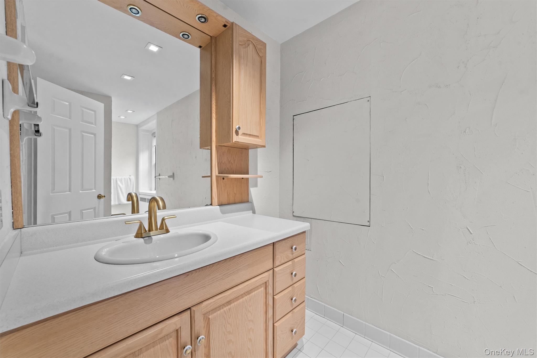 341 Furnace Dock Road, Unit 5 Cortlandt Manor, NY 10567 - Photo 21 of 41 a bathroom with a sink and a mirror