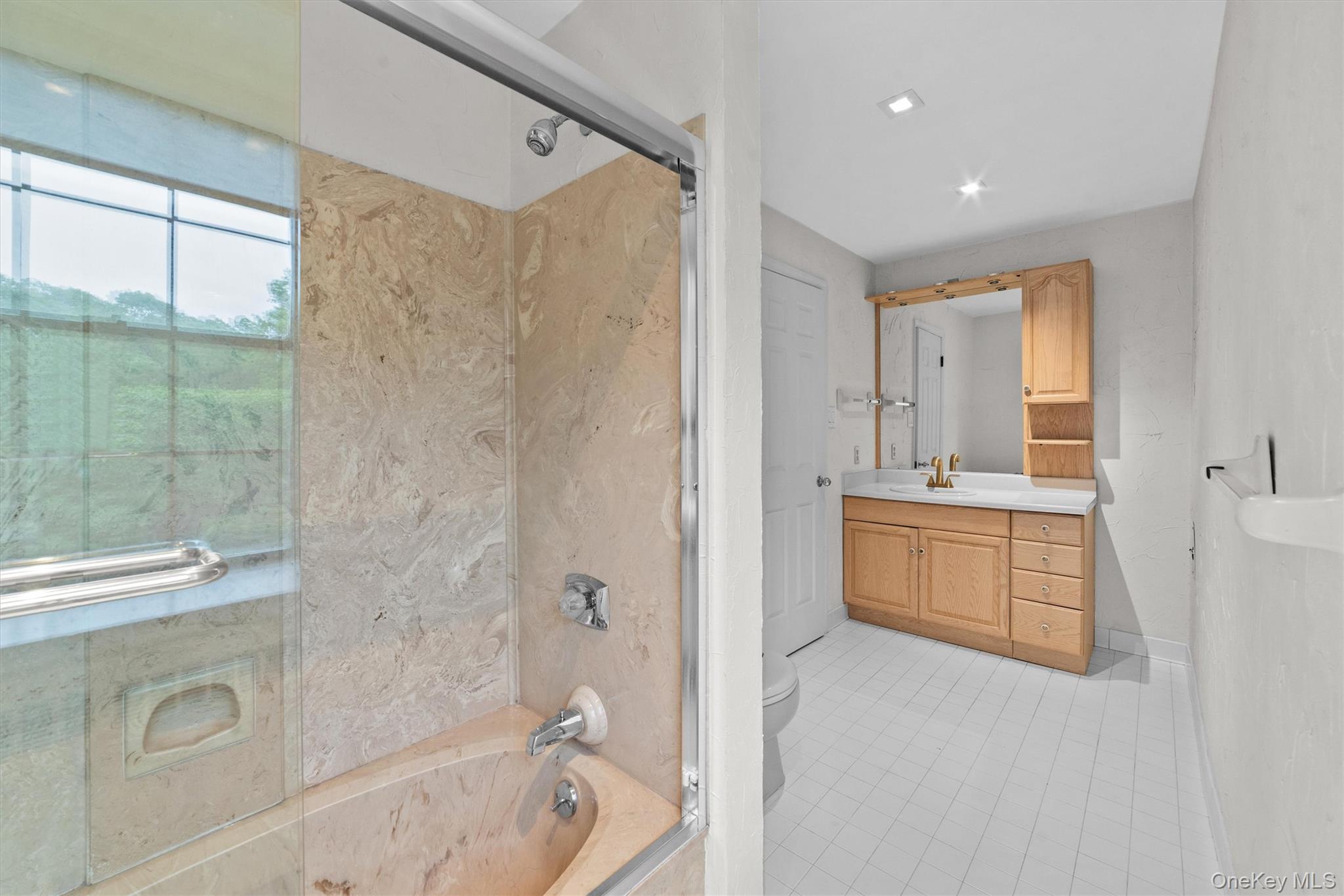 341 Furnace Dock Road, Unit 5 Cortlandt Manor, NY 10567 - Photo 22 of 41 a bathroom with a double vanity sink toilet mirror and bathtub