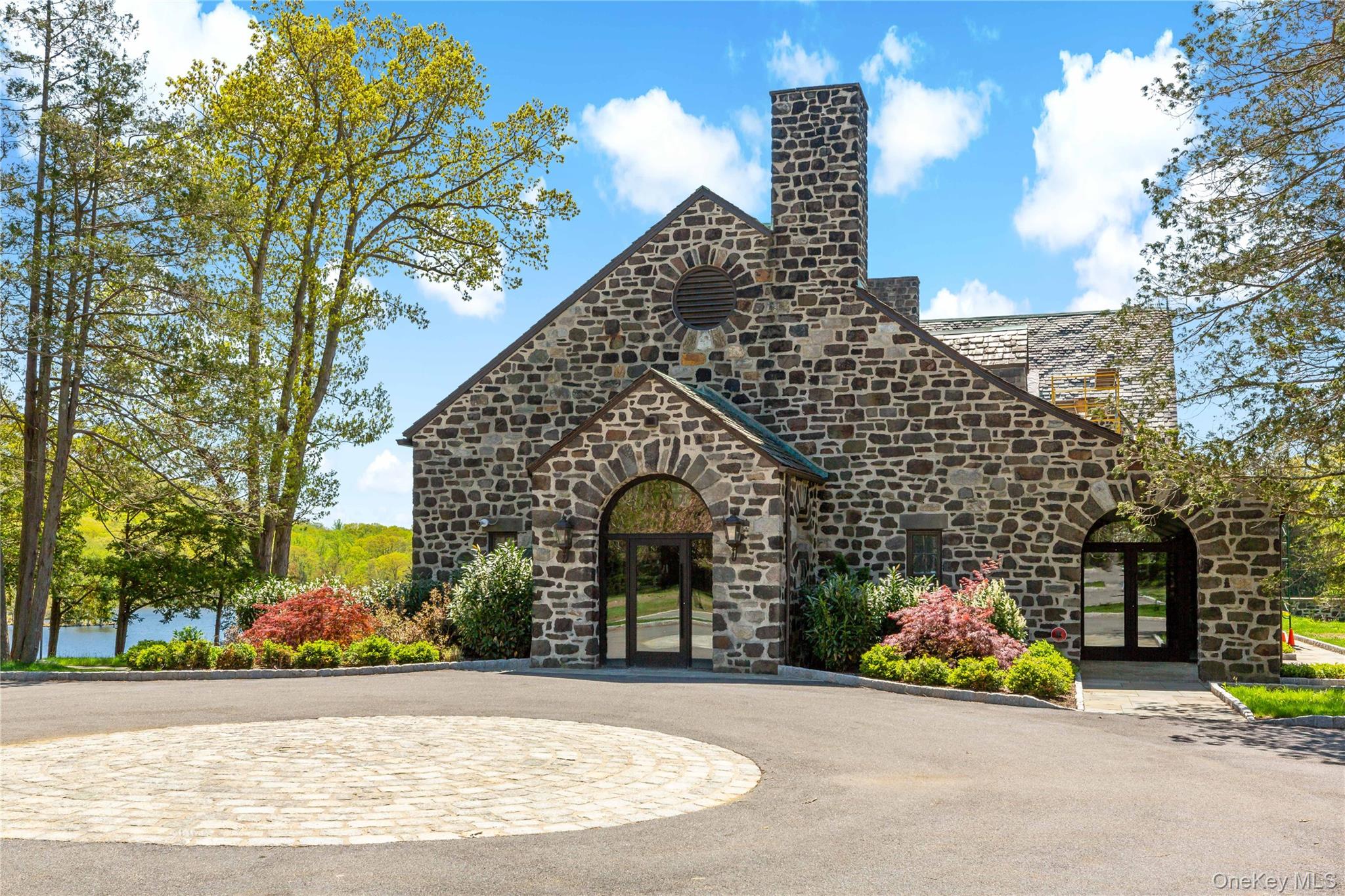 341 Furnace Dock Road, Unit 5 Cortlandt Manor, NY 10567 - Photo 28 of 41 a front view of a house with a garden and trees