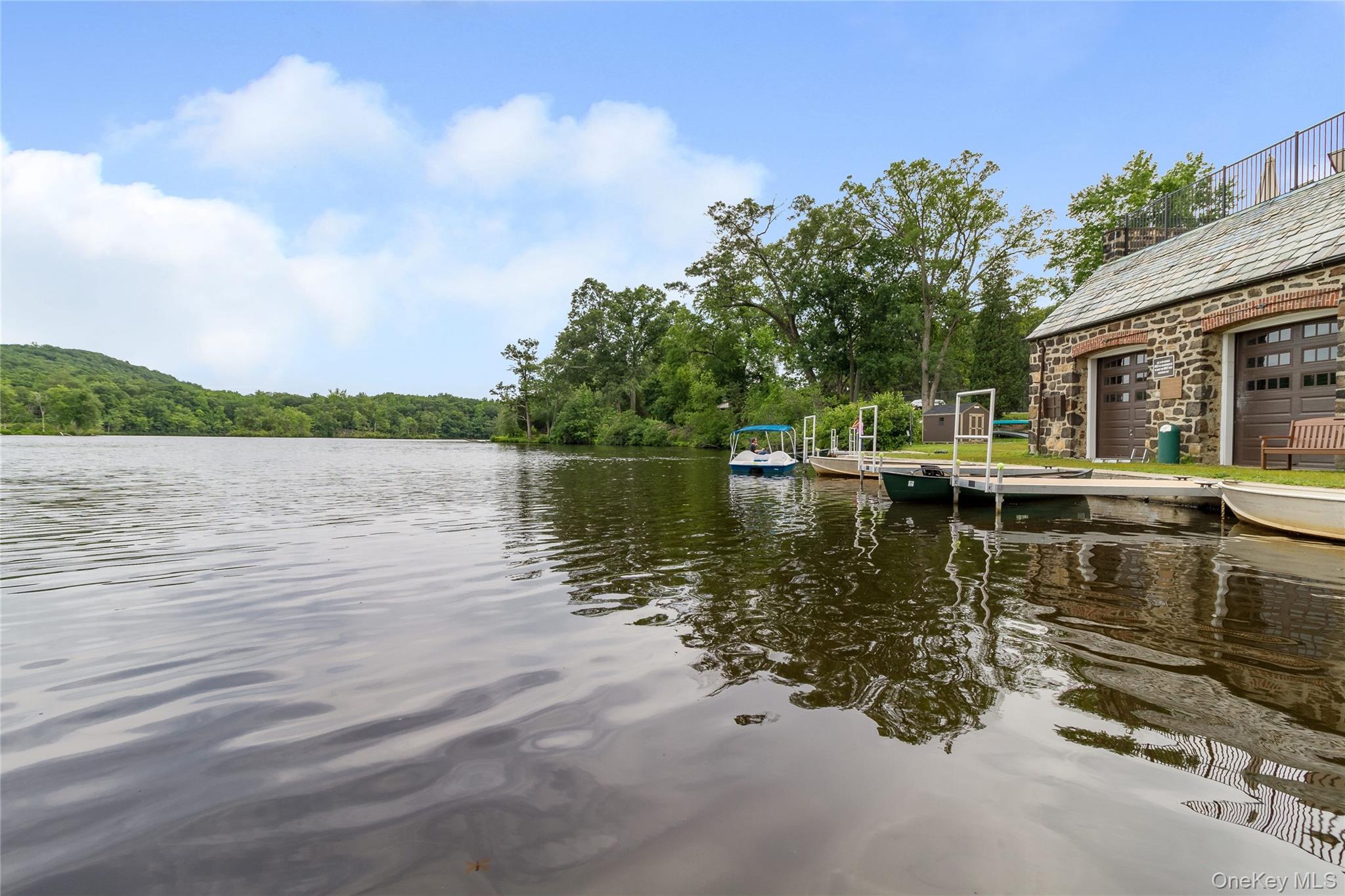 341 Furnace Dock Road, Unit 5 Cortlandt Manor, NY 10567 - Photo 29 of 41 a view of a lake with houses in the background
